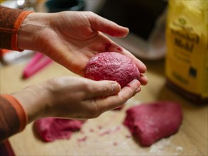 Hand moulding the dough for beetroot burger buns