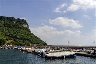 Harbour with boats and the Rocca di Garda mountain in Garda