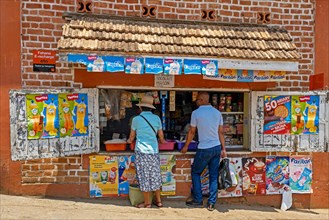 Malagasy customers buying food in little grocery shop in the city Fianarantsoa