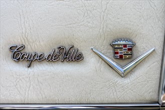 Logo and model designation on classic car Cadillac Coupe DeVille on soft top