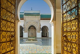 Main entrance with bronze doors and courtyard of the al-Qarawiyyin Mosque and university in the old medina of the city Fes