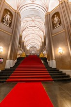 Interior of the Rotes Rathaus with red carpet and elegant staircase