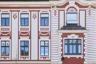 Red and white painted facade of an Art Nouveau house from 1908 on Dreifaltigkeitsplatz
