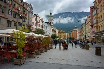 Tourists in the city centre of Innsbruck with the Karwendel mountains in the background