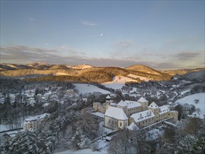 Aerial view of the castle and church in winter at sunrise