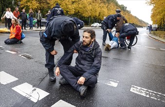 Police officers carry last generation climate activists from Strasse des 17. The Last Generation has called for a mass occupation action