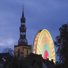 Tower of St Peter's Church with Ferris wheel
