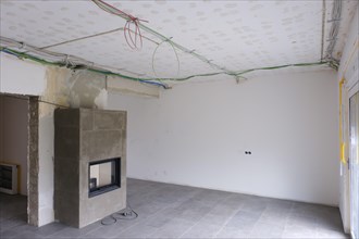 Room with newly laid electrical cables under the ceiling