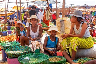 Malagasy girls and children selling fruit and vegetables at food market in the city Ambalavao