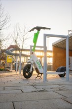 Electric scooter line in the park at sunrise as a symbol of environmentally friendly mobility