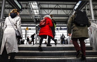 Commuters at Ostkreuz station walk to the train