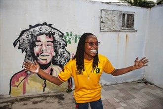 Tour guide Susan Maxwell in front of Bob Marley mural
