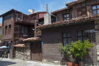 Traditional wooden houses with balconies under a blue sky