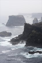 Sea stacks and cliffs in the mist at Eshaness