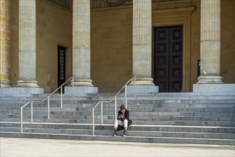 Tourist sitting in front of Museum of Fine Arts