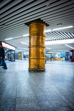 Shiny column in a modern underground station with minimalist lighting