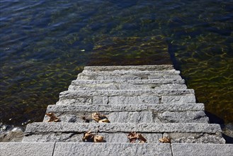 Steps into the water of Lake Maggiore on the shore in Ascona