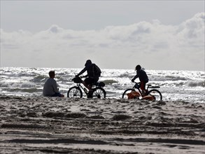 Cyclist on a North Sea beach in Vejers