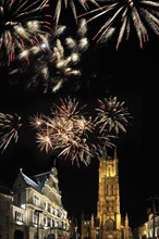 Colourful fireworks above the Saint Bavo's Square with theatre and the Saint Bavo's cathedral at night