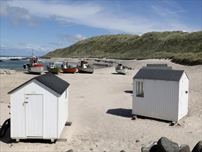 Fishing boats and small changing cabins on the beach of Lonstrup