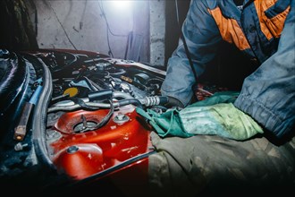 Car repair by an auto mechanic in a car service center