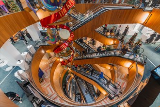 Festively decorated department stores' with several escalators and modern design