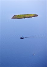 Aerial view of a small island and a leisure boat on the Edersee