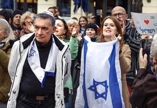 Participants in the march in solidarity with Israel display placards and Israeli flags