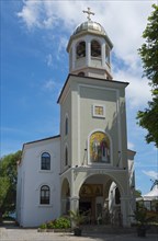 Orthodox church with bell tower under a clear blue sky