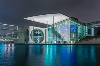 Night view of a government building with water reflection
