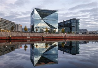 The cube Berlin building at Berlin Central Station is reflected in the River Spree
