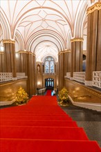 Interior of the Rotes Rathaus with red carpet and elegant staircase
