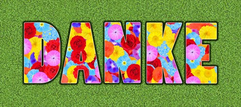 The word thank you written with colourful flowers on a green meadow