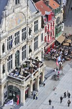 Tourists dining at balcony of the theatre at the Saint Bavo's quare in Ghent