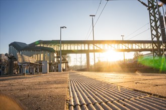 Morning atmosphere with a bridge architecture over railway tracks at sunrise