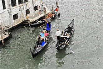 Gondoliers in traditional gondolas
