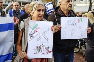 Iranian participants in the demonstration Solidarity March with Israel show posters and Israeli flags