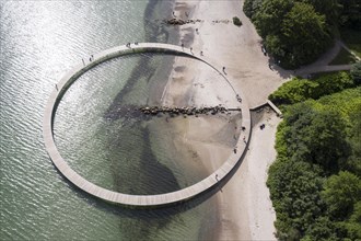 An aerial view shows people walking on the infinite bridge. The bridge is a work of art built by Sculpture by the Sea