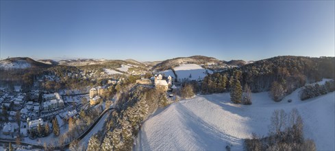 Aerial view of castle and church in winter