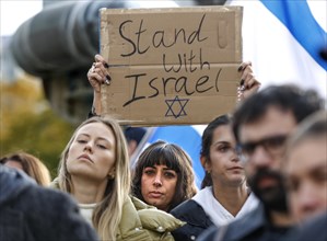 A participant in the demonstration Solidarity March with Israel shows a poster with the inscription Stand with Israel