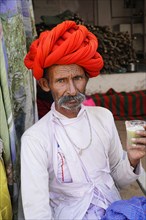 Indian man drinking sugar cane juice