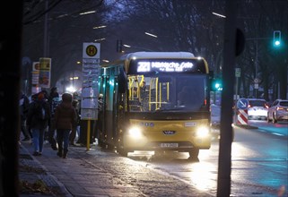Passengers boarding a Berlin public transport bus in the evening