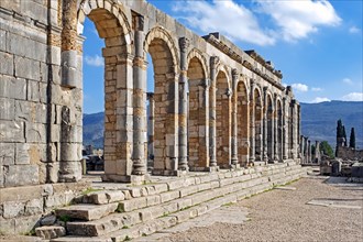 Arched outer wall of basilica faced with columns at Volubilis