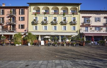 Restaurants in pastel-coloured houses on the Piazza Giuseppe Motta promenade in Ascona