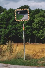 Traffic mirror on a rural road next to fields, Osterholz, Wuppertal, North Rhine-Westphalia,
