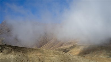 Low hanging clouds in the mountain landscape at the Tizi-n-Tichka pass road, High Atlas, Morocco,