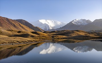Mountains reflected in a small mountain lake, Pik Lenin, Trans Alay Mountains, Pamir Mountains, Osh