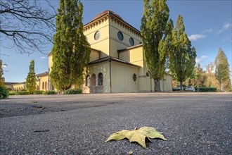Church with striking shapes, a fallen leaf on the street, cemetery, Pforzheim, Germany, Europe