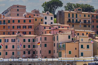 Interlocking houses with pastel-coloured facades in Rio Marina, Elba, Tuscan Archipelago, Tuscany,