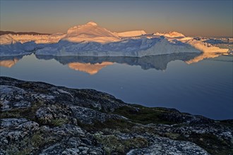 Reflection of icebergs, midnight sun, summer, Ilulissat Icefjord, Disko Bay, Jakobshavn Glacier,